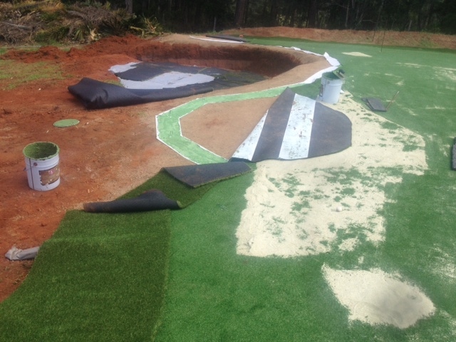 making sure the synthetic grass is laid perfectly...