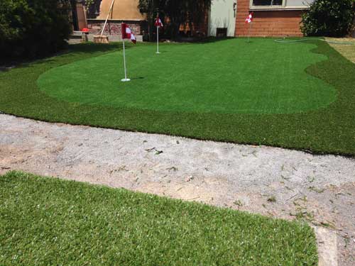 Putting green with chipping mat at bottom of screen.